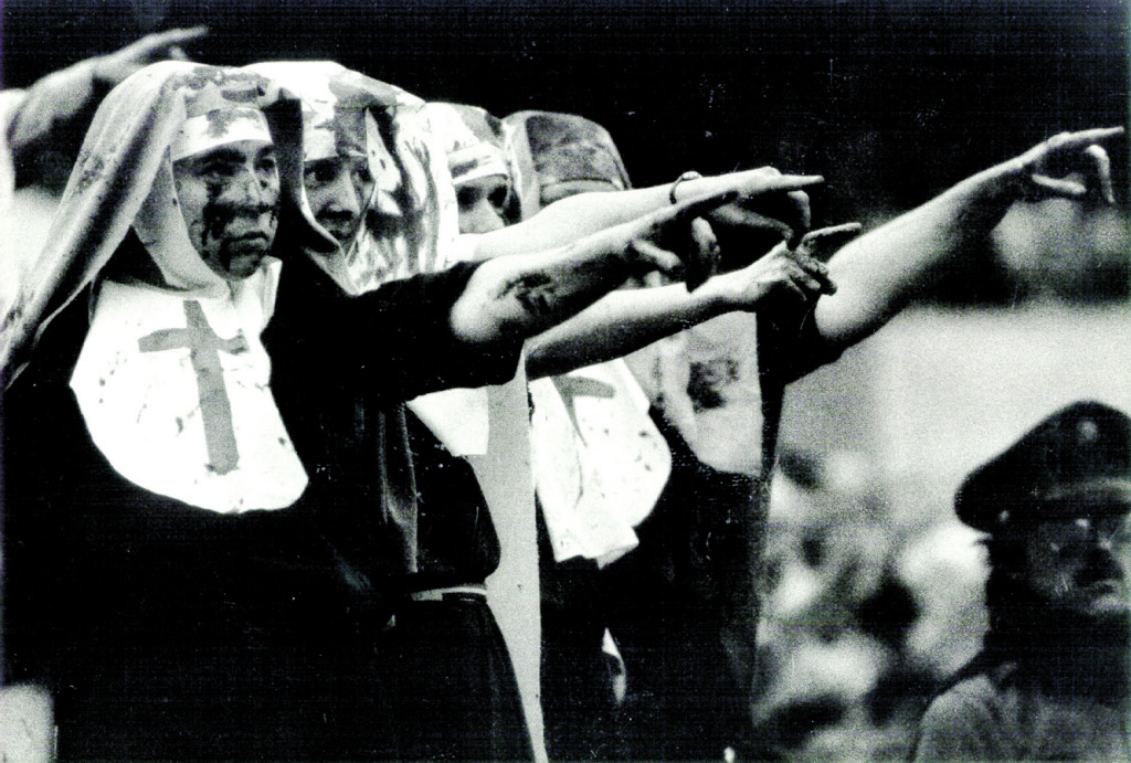 Cynthia Squillace, Wendy Kohli and other peace activists point bloodied fingers at Secretary of State Alexander Haig during his Carrier Dome address at Syracuse University commencement in May 1981.