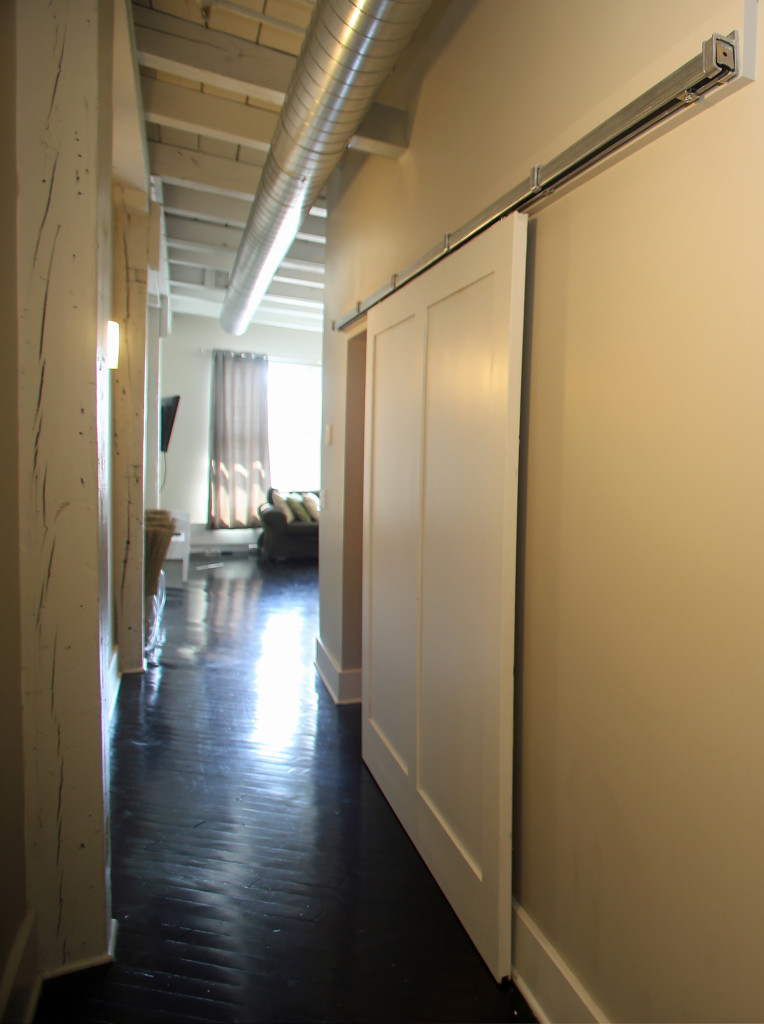 Pike Block resident Beth Egan said she "fell in love with" the sliding door to a bedroom. (Gloria Wright Photo | Syracuse New Times)