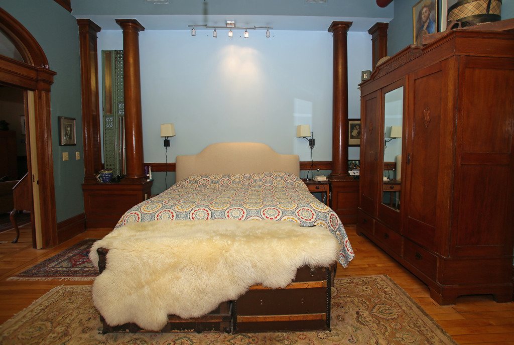 The oak columns on either side of the bed were moved from another part of the apartment. Gloria Wright Photo | Syracuse New Times.