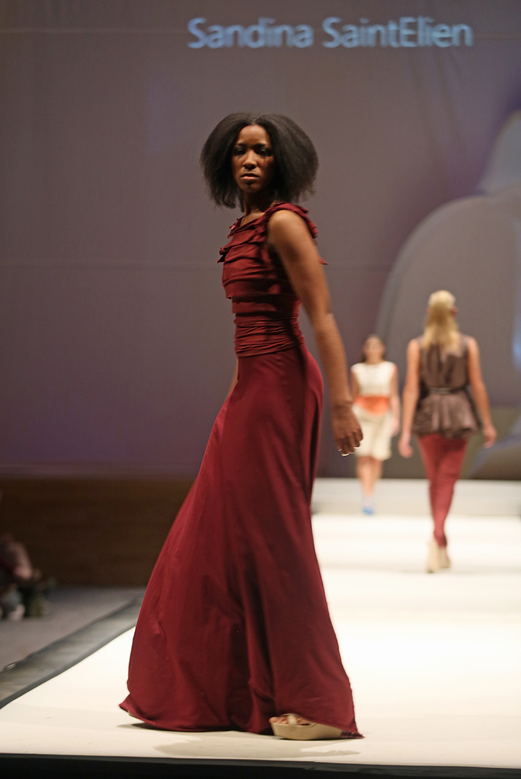 Syracuse University senior Sandina SaintElien (CQ) designed a dress shown at the SU Senior Collection Fashion Show at Goldstein Auditorium. The annual show presents the work of seniors in the College of Visual and Performing Arts fashion design program. Gloria Wright | Syracuse New Times