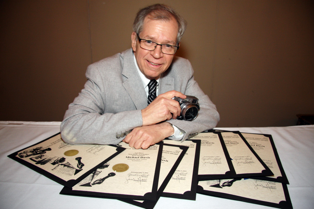 New Times photographer Michael Davis won seven Syracuse Press Club awards, six of them against competition that included all print media in the region. Four of them were for first place in a category. Photo by Herm Card/Courtesy of Syracuse Press Club
