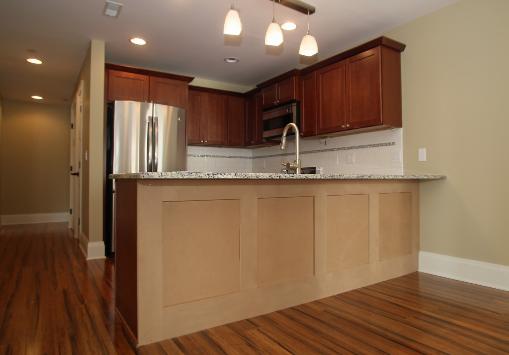 The kitchens in the Courier Building have granite counters, stainless steel appliances and gas stovetops with convection ovens. Photo by Gloria Wright | Syracuse New Times