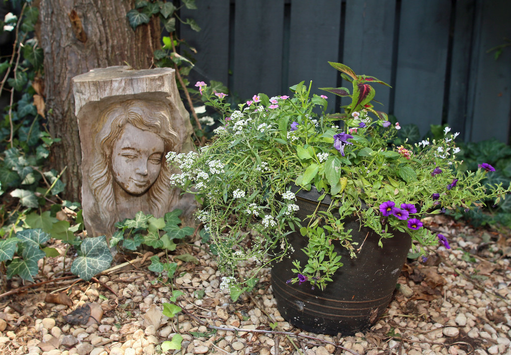 A garden decoration left by the original owner of a Mission Landing condo decorates a sunny courtyard. Photo by Gloria Wright