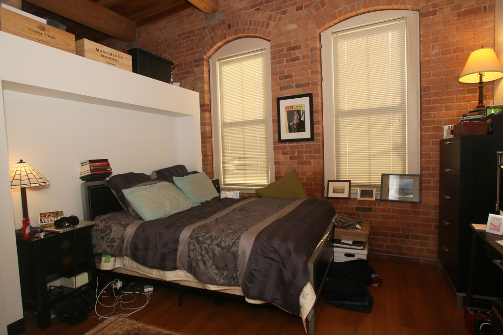 A three-quarters wall divides the living area from the bedroom in an apartment at Nettleton Commons. Gloria Wright Photo | Syracuse New Times