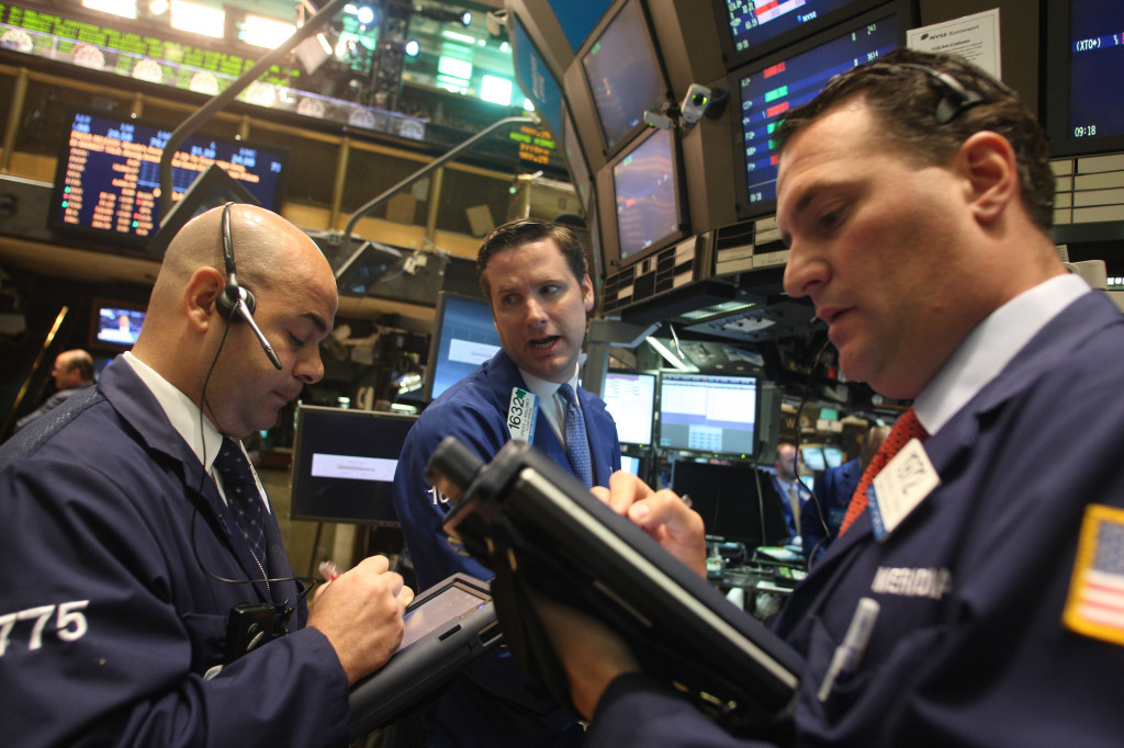Stock Traders work on the floor of the New York Stock Exchange before the opening bell. (Hiroko Masuike for The New York Times)