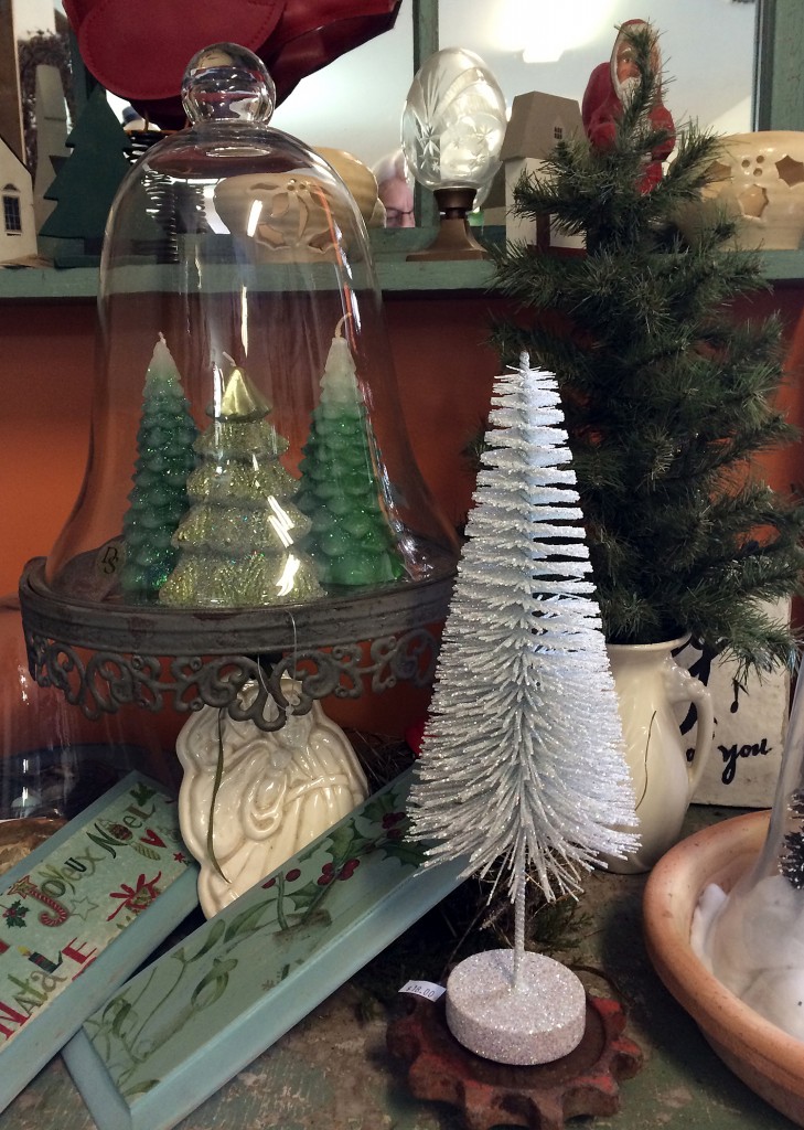 Tree candles under a bell jar, a small tree in a vase and a white bottle tree for $18 are available at Carol Watson Greenhouse, 2980 Sentinel Heights Rd, LaFayette.