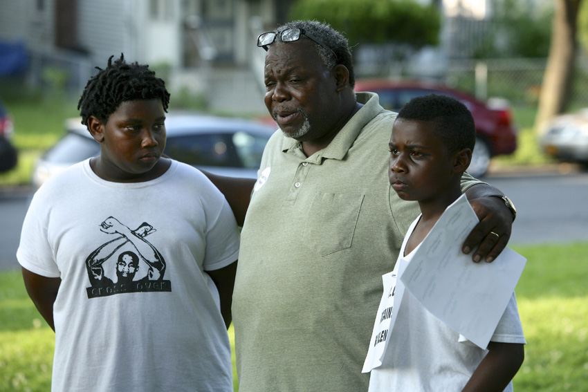Pastor Lorenzo Brown with Zuriel and Zacaria Dickerson. Michael Davis Photo | Syracuse New Times