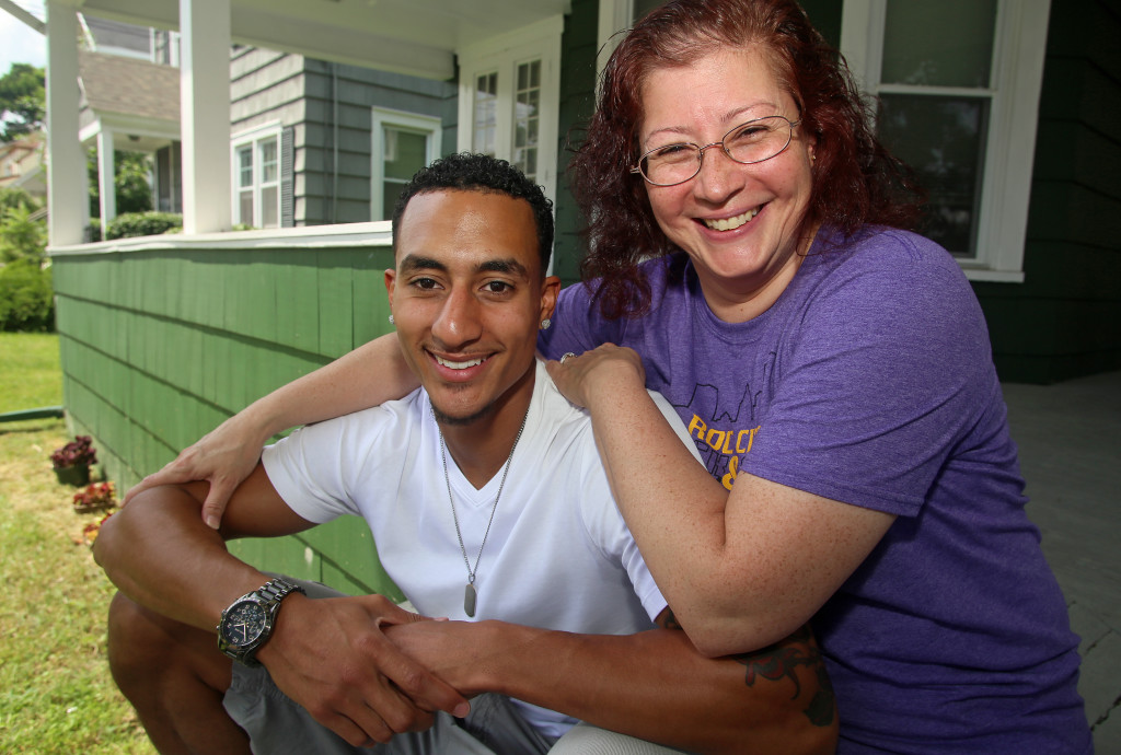 Wendall Williams and his mother, Claudinne Clarke, on the front steps of their home on Glenwood Avenue. Michael Davis Photo | Syracuse New Times