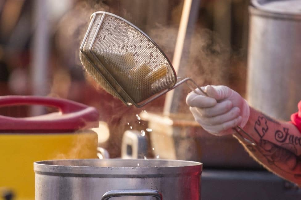 A basket of wings is tossed in breadcrumbs at Wing Fest 2018
